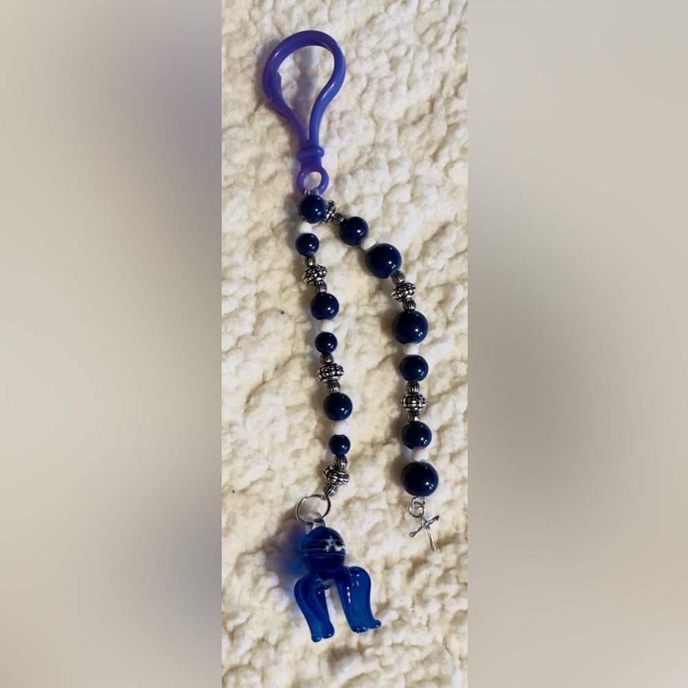 Handmade Glass octopus with metal cross keychain.